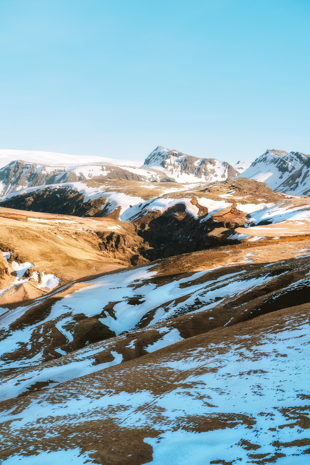 Brown Mountain With Snow during Dayitme